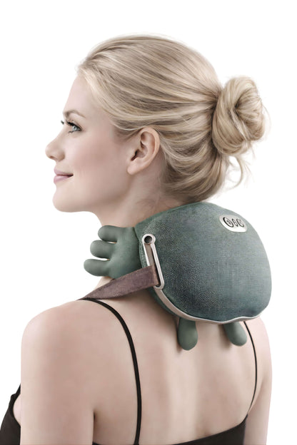 Woman wearing a green neck and shoulder massager.